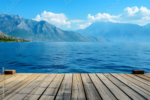 deck wooden surface with sea view and mountains overlooking sea © Yi_Studio