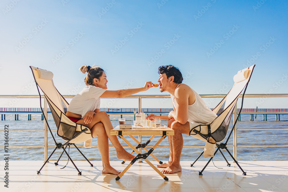 Asian couple lover enjoy their holiday at the sea in the summer with beautiful clear sky ocean.