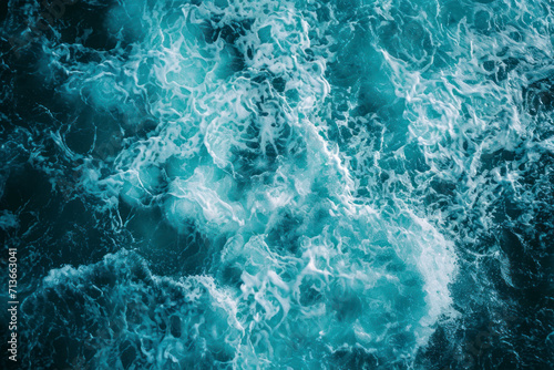 From above aerial view of turquoise ocean water with splashes and foam for abstract natural background and texture. photo