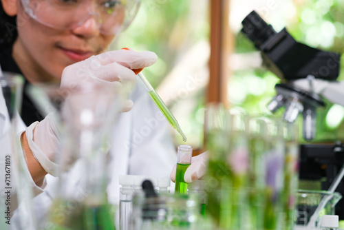 Young Scientist woman, laboratory and test tube with plants, research and analysis of leaves for ecology. science expert, health and care study of plant for pharma, medicine or sustainable medicine.