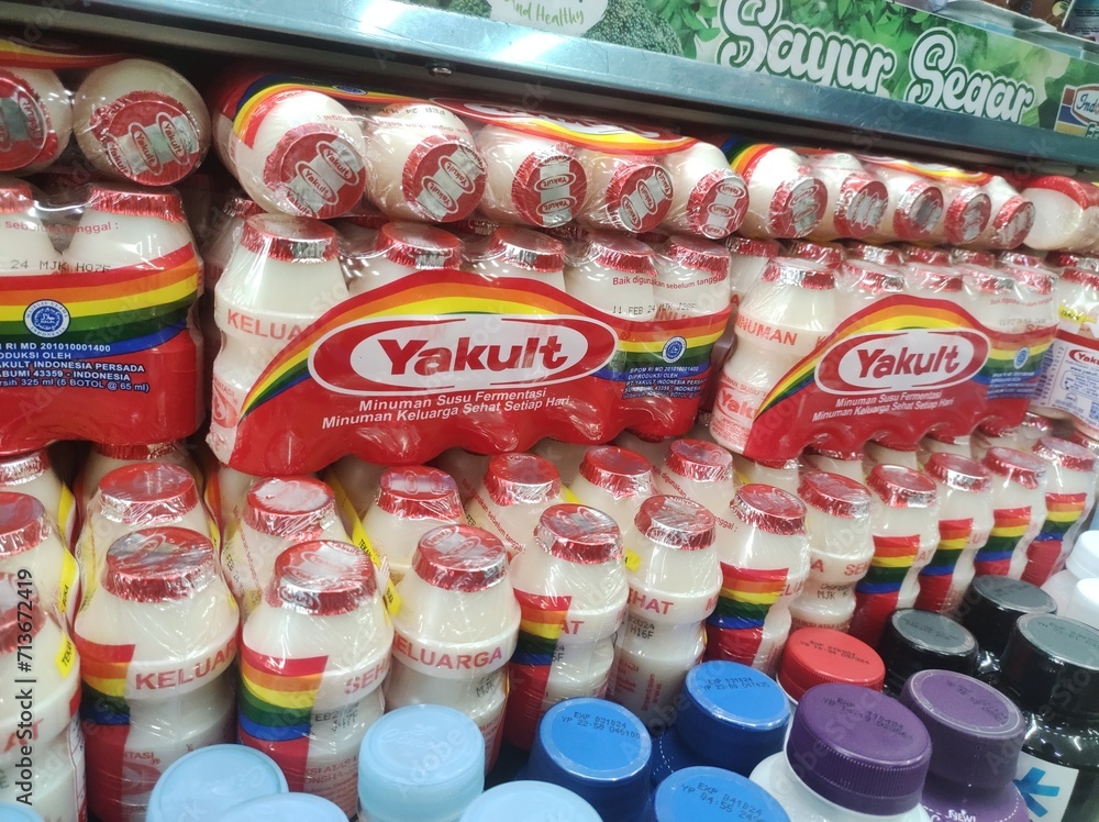 bottles of Yakult probiotic milk on a supermarket shelf. This is a