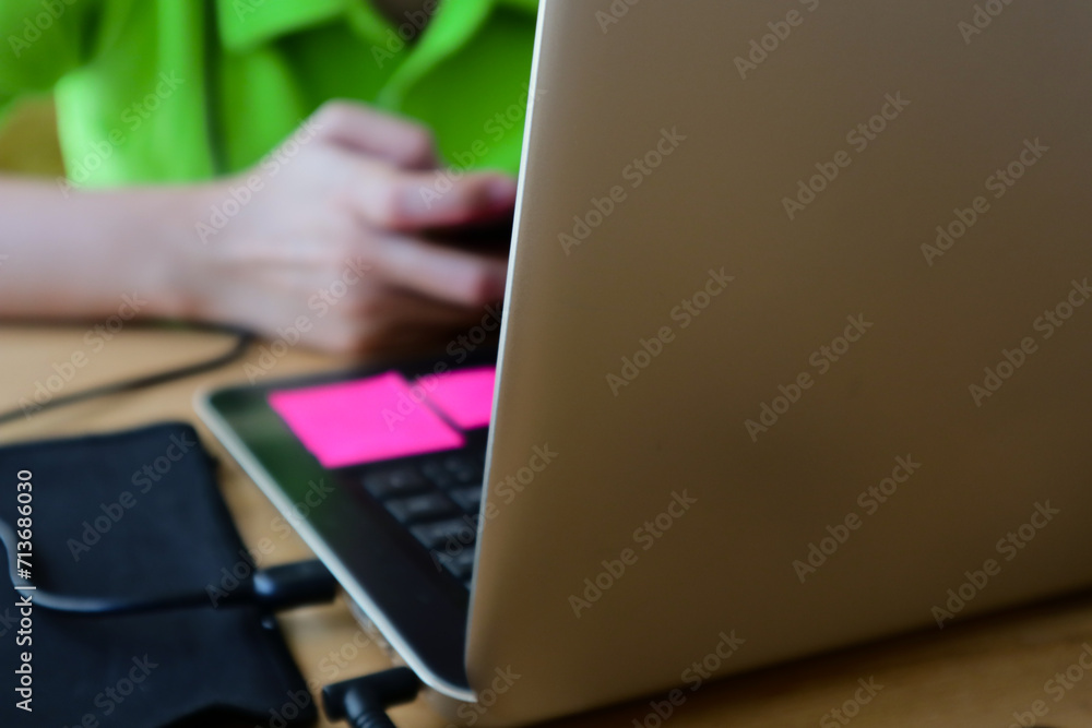 Fototapeta premium a woman's hand playing mobile phone while working
