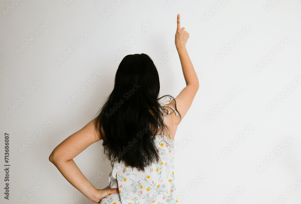 a woman points in a direction from the back view a woman points in a direction from the back view