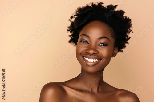 Beautiful African woman celebrating clear skin, beige background