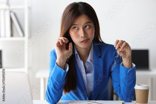 Asian businesswoman is stressed and has a headache from overwork.