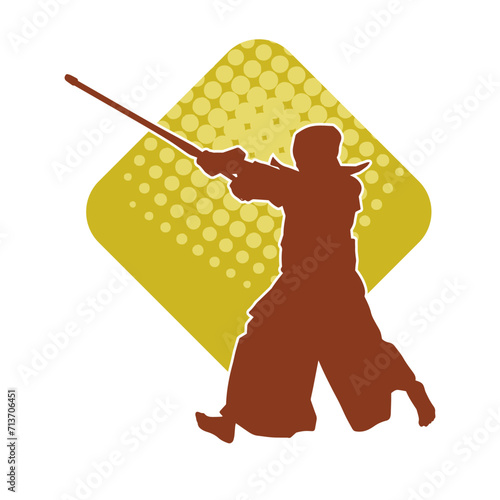 Silhouette of a kungfu or wushu martial art athlete in action pose. Silhouette of a male martial art person in pose with swords weapon.
