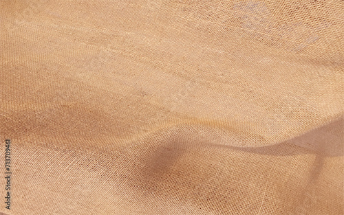 Texture brown canvas fabric as background. Cloth a sacking. Texture to host your image or text. Background of burlap hessian sacking.