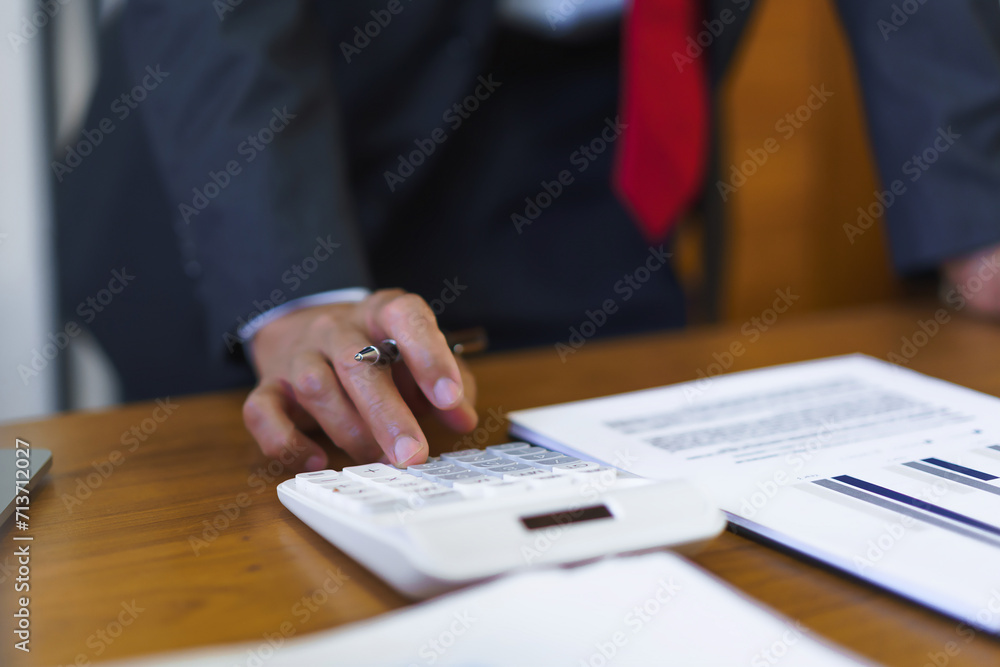 Financial business concept, Senior businessman use calculator to calculate business cost and profit Financial business concept, Senior businessman use calculator to calculate business cost and profit