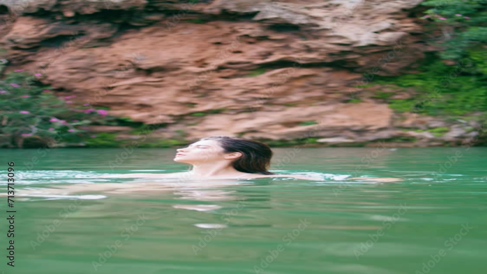 Naked woman swimming lagoon in beautiful summer nature vertically. Lady in lake Naked woman swimming lagoon in beautiful summer nature vertically. Lady in lake