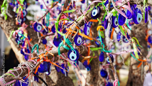 A Wish Tree or Dilek Agaci in Turkish with evil eye pendants to ward off negative energy and fulfil one's desires at the Pigeon Valley Panoramic point near Goreme,Cappadocia Region, Turkey