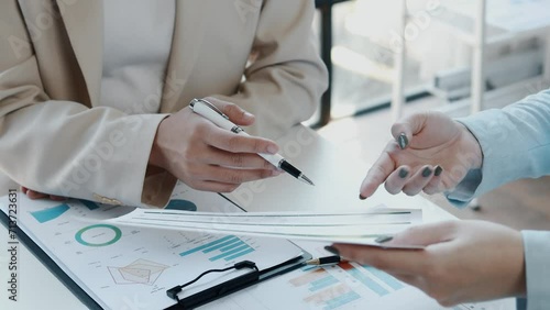Explaining the report at the meeting, Collaborate to solve problems in the meeting room, Discuss startup business with the team at the office, Mixed group of business people sitting around a table.