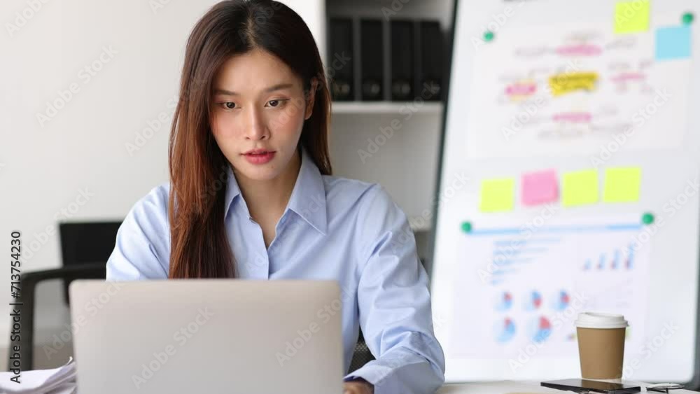 Serious businesswoman working on paperwork and laptop on office desk. Serious businesswoman working on paperwork and laptop on office desk.