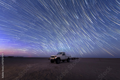 night Star trailing motion with Gemini Meteors shooting in safari desert camping photo