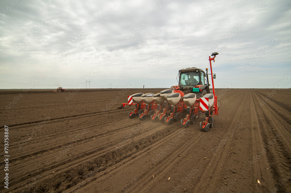 Fototapeta premium Sowing crops at agricultural fields in spring