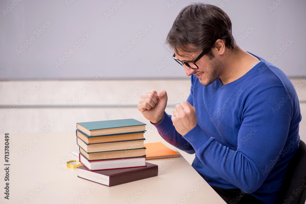 Young male student preparing for exams in the classroom Young male student preparing for exams in the classroom