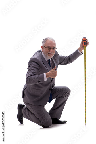 Old businessman holding tape measure isolated on white © Elnur