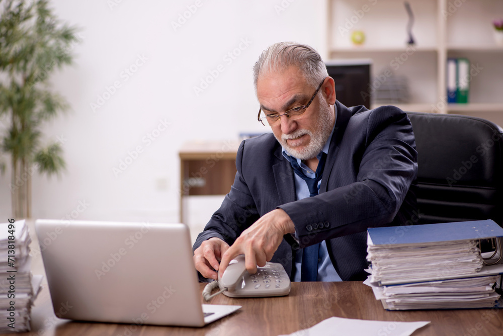 Old male employee and too much work in the office Old male employee and too much work in the office