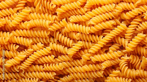Close-up top view of traditional italian pennettine pasta as an abstract background
