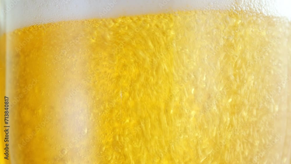 Beer pours into a glass, forming effervescent bubbles and a frothy head. Detail shot, macro. beer capturing the spirit of octoberfest celebration . alcoholic drink Beer pours into a glass, forming effervescent bubbles and a frothy head. Detail shot, macro. beer capturing the spirit of octoberfest celebration . alcoholic drink