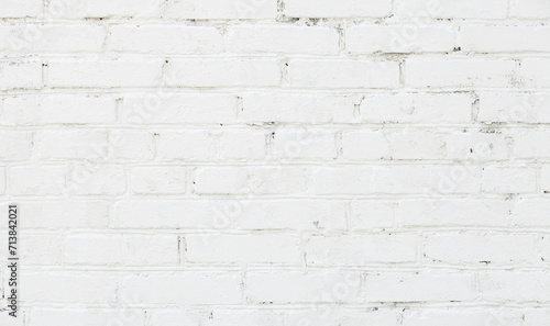 White brick wall background. Old brick wall texture with white cracked paint. Abstract white brick wall wallpaper design. Close up.