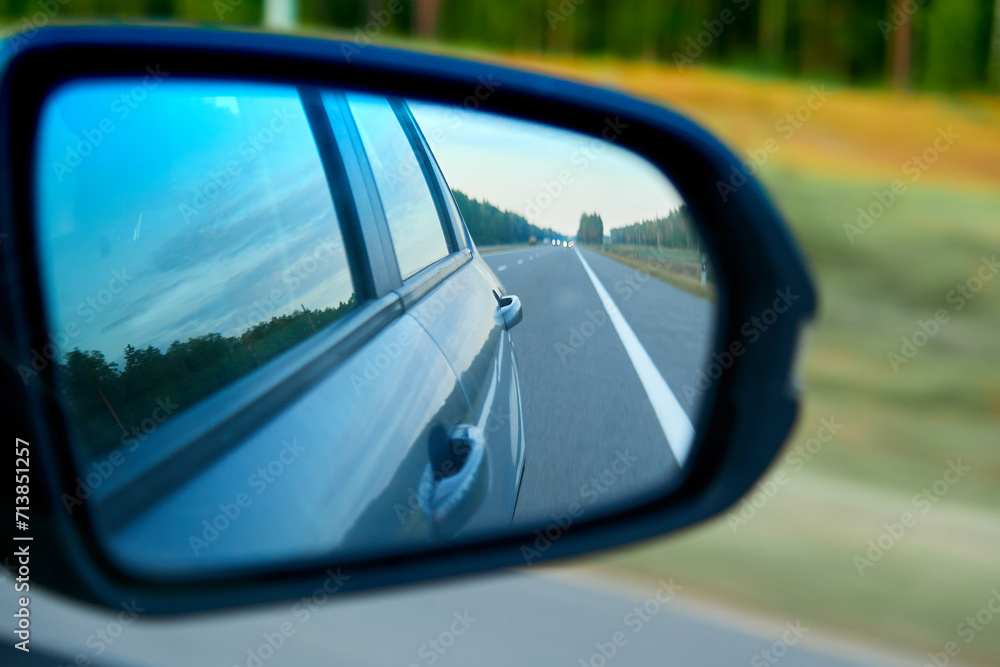 The road in the rear view mirror of a car The road in the rear view mirror of a car
