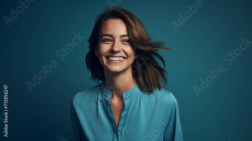 Caucasian woman wearing a shirt on a blue background.