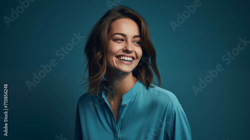Caucasian woman wearing a shirt on a blue background.