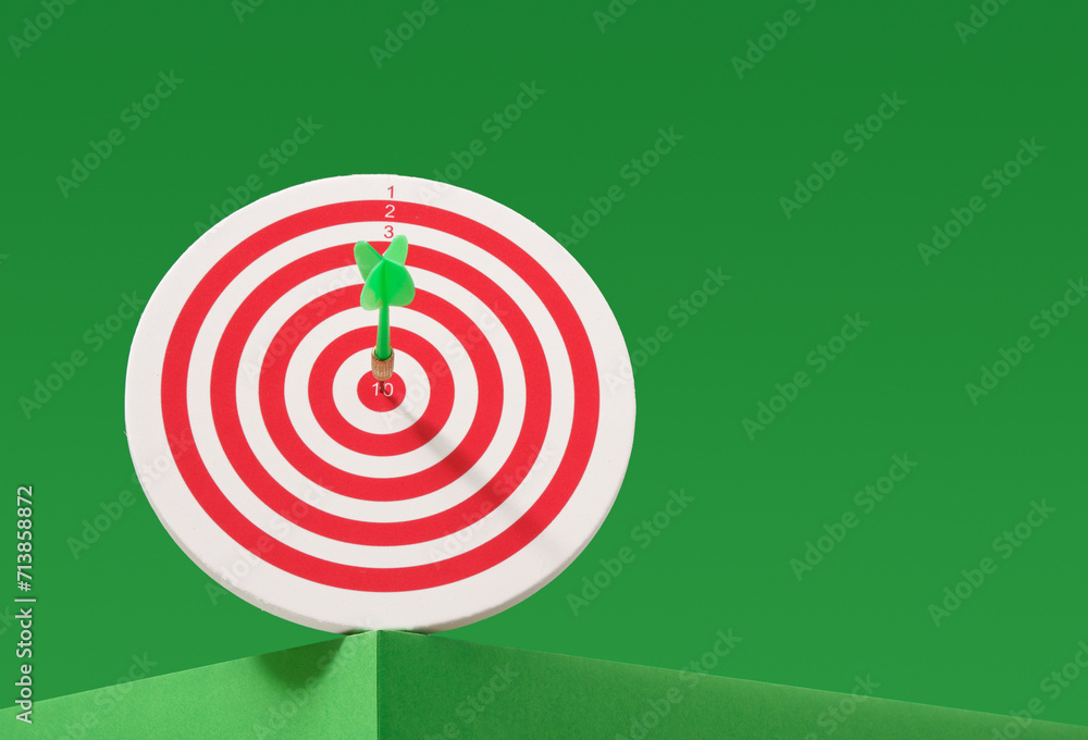 Round brightly colored target and arrow. Game of darts. Copy space for text. Precision and victory. Round brightly colored target and arrow. Game of darts. Copy space for text. Precision and victory.