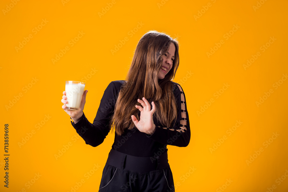 Girl with glass of milk doesn't like it. Dairy Intolerant person. Lactose intolerance, health care concept. Girl with glass of milk doesn't like it. Dairy Intolerant person. Lactose intolerance, health care concept.