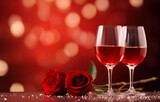 wine glasses on red background with rose on the red light