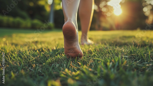 close up of the bare feet of a person walking on the grass, therapy and reduce stress in living and investing and doing business