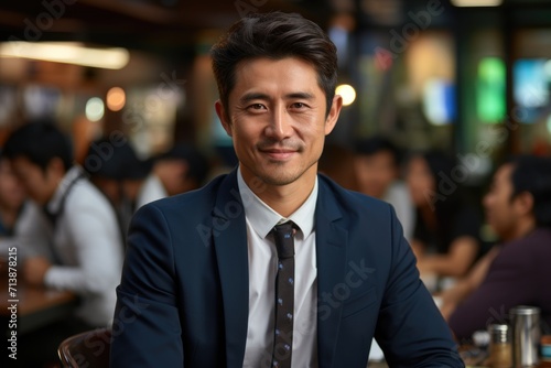 Smiling Businessman in Busy Cafe