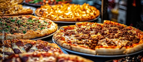 A mouthwatering spread of italian flatbread topped with gooey pizza cheese and a variety of savory toppings, perfect for a quick snack at a bustling indoor shop in california photo