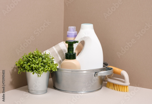 Household chores and cleanliness. A metal basin with detergents and household equipment.