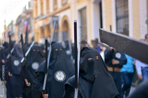 the hooded penitents with the cross on their shoulders ready for the procession