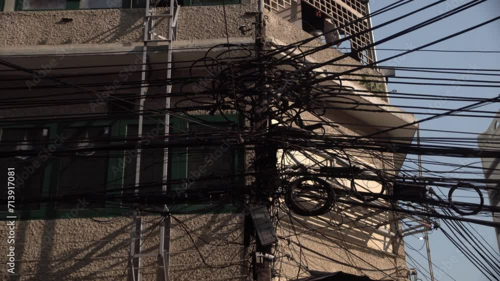 Electrical wires , A large number of electrical wires hang above the streets in the city of Bangkok, Thailand. Electrical wires , A large number of electrical wires hang above the streets in the city of Bangkok, Thailand.