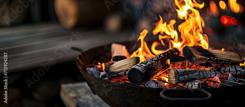 Freshly lit barbecue fire with logs of burning wood over small chips of kindling in a portable BBQ. Creative Banner. Copyspace image