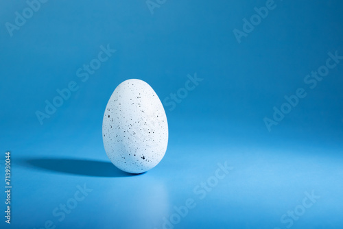 Easter egg on blue background, spring celebration, festive egg hunt
