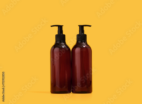 Two brown shower gel dispensers. Body care and shower.