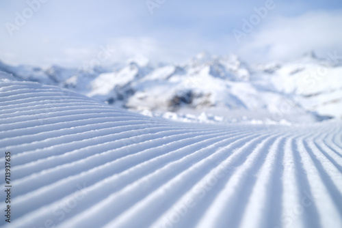 Snow slope for skiing and snowboarding. Velvet. Winter sports. Slope and mountains. Composition in winter time. Wallpaper and background.