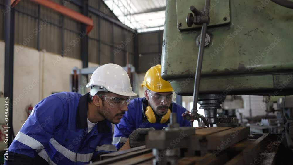 Blue collar workers are working at metal factory. Blue collar workers are working at metal factory.