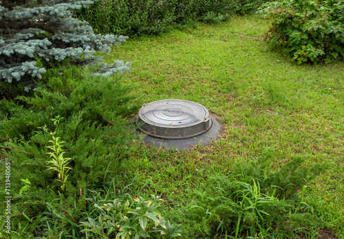 Cuadro en lienzo Sewer hatch of a cesspool on the site of a rural house.