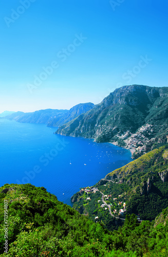 Amalfi Coast, Positano, Peninsula of Sorrento, Campania, Italy. View from Path of the Gods, Sentiero degli Dei. Town Positano on the right. Island Capri in the background.