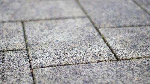 Close-Up View of Gray Paving Stones Texture in Urban Setting During Daytime