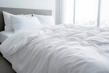 Close up of folded duvet on white bed in the background of modern bedroom. Building concepts and healing and relaxation.