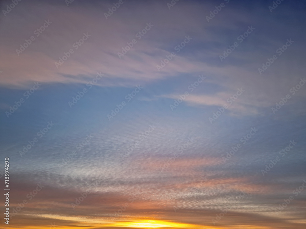 Beautiful winter sunset sky background. Colorful dusk clouds