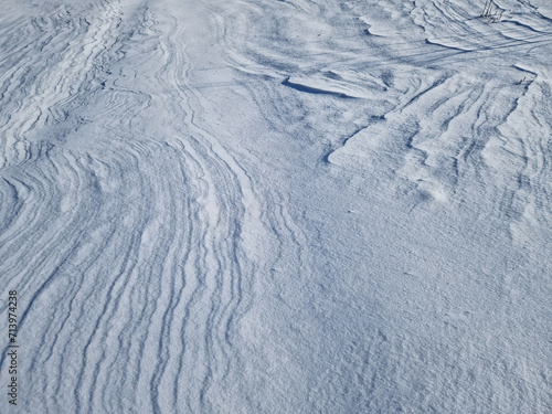 Winter snowdrifts abstract texture of snow shaped by the wind on an empty land