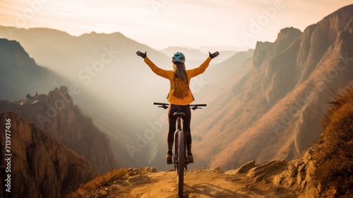 Fotografia, Obraz Happy woman with open arms on bike high in mountains
