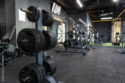 Gym, equipped with weights and various exercise tools, creating environment for effective workouts and strength training