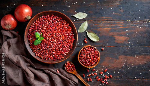 Top view of red legumes on a dark wooden kitchen table. Healthy food concept and detox or vegan menu. World Pulses Day. Copy Space.